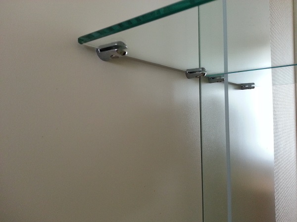 6mm glass shelves fitted into an alcove with small chrome brackets chrome shelf brackets